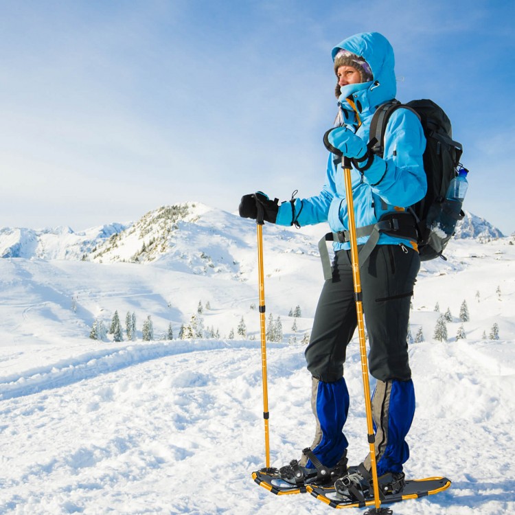 Adult using 4-in-1 lightweight terrain snowshoes with ski poles in snowy landscape, designed for maximum flotation and.